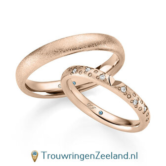 Trouwringen in 14/18 karaat ros&eacute;goud bewerking glamour met geslepen hart en in de damesring 6 diamanten golvend