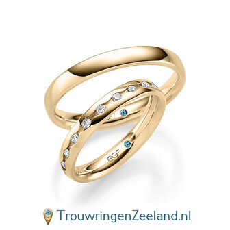 Trouwringen in 14/18 karaat geelgoud glans met in de damesring 19 diamanten geheel rondom waarbij elke diamant als een oog is gezet.