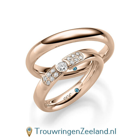 Trouwringen in 14/18 karaat roségoud glans met in de damesring 1 grote diamant geklemd in een ronde zetting en aan weerszijden 6 kleinere diamanten pavé gezet